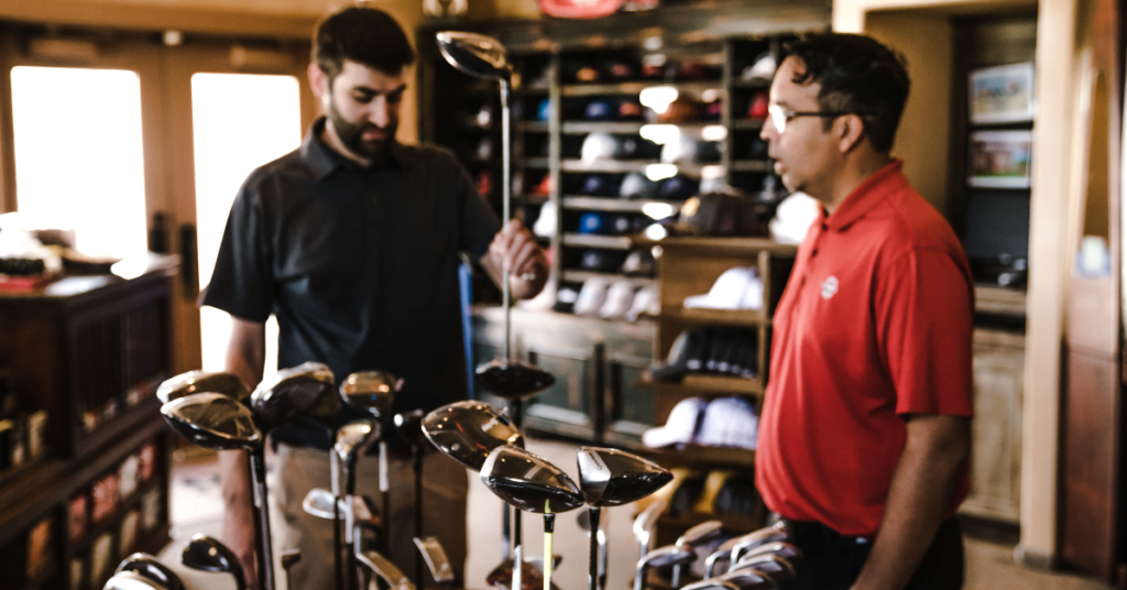 Two golfers looking about to give golf club reviews about a driver.