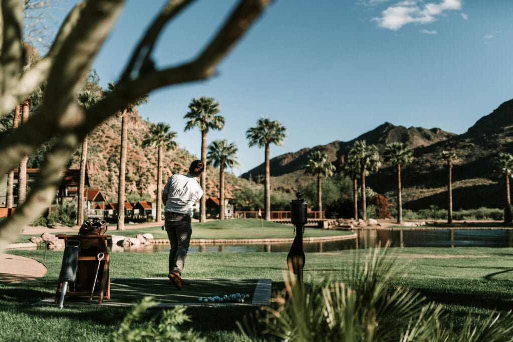 man practicing golf shots on golf course